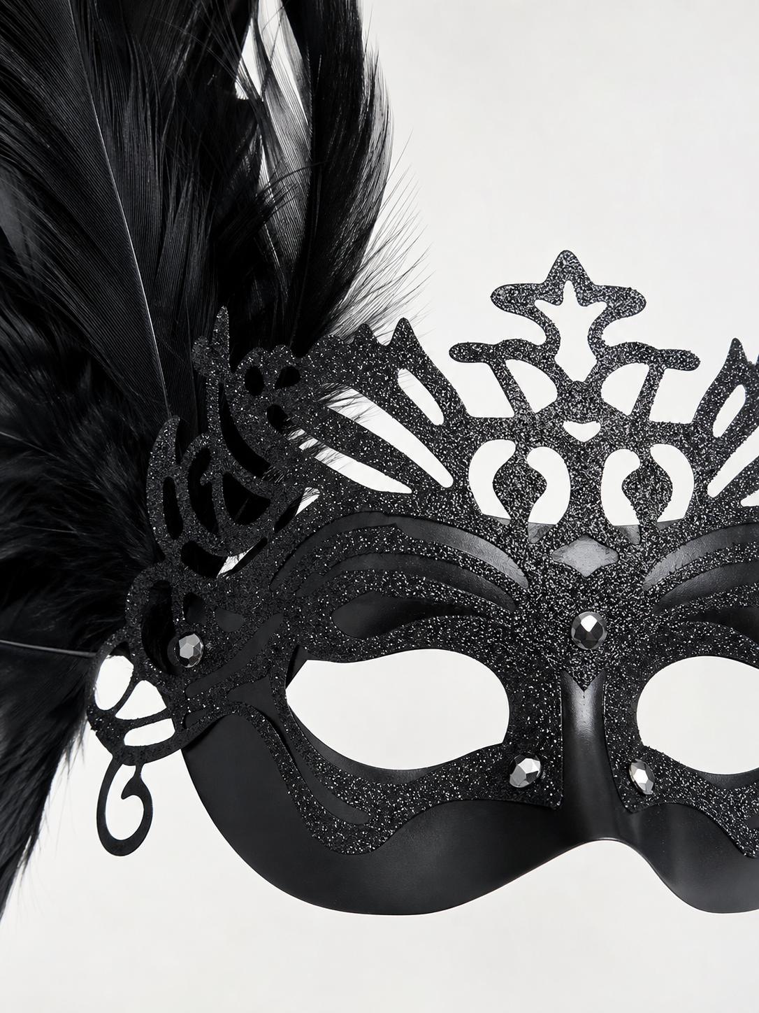 Carnival headpiece with black feathers and a mask