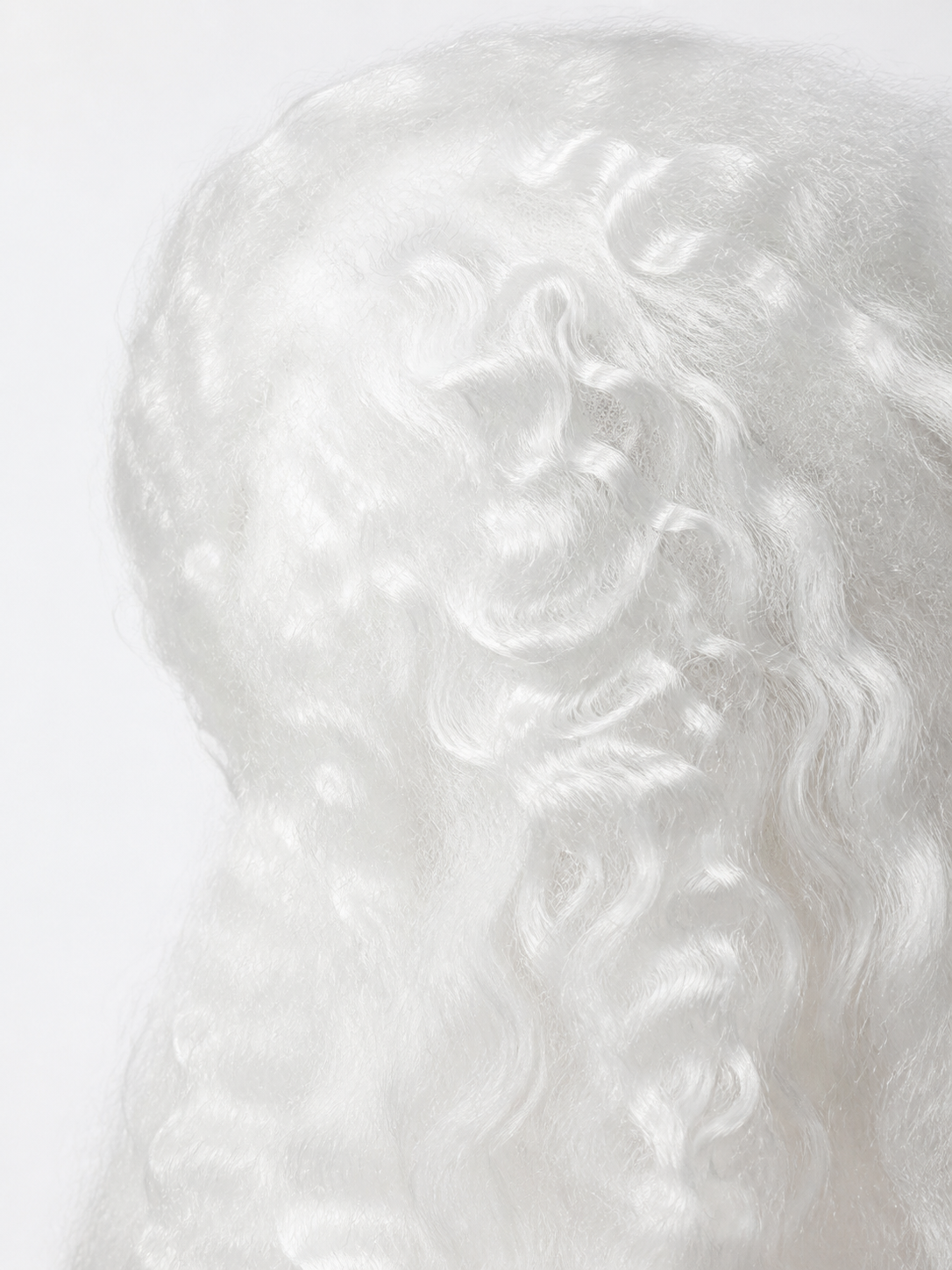 Close-up of the white wig fibers, showing soft curls and a wavy synthetic hair texture