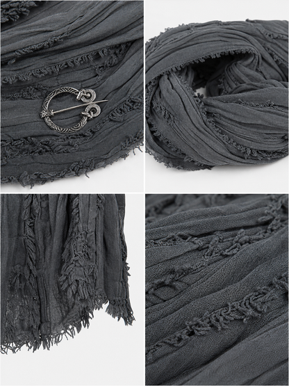 This large scarf-wrap is designed as a rectangular drape with a striking textured surface. The black-and-gray color palette is accented with lighter gray tones, giving the piece a distinctive look that pairs easily with different outfits. T