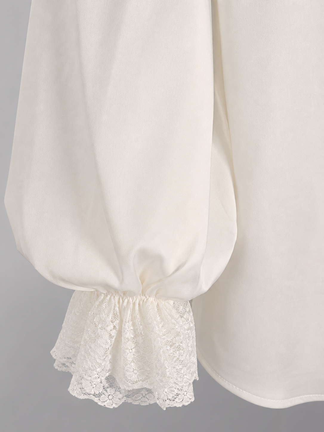 White blouse with a high collar and ruffles