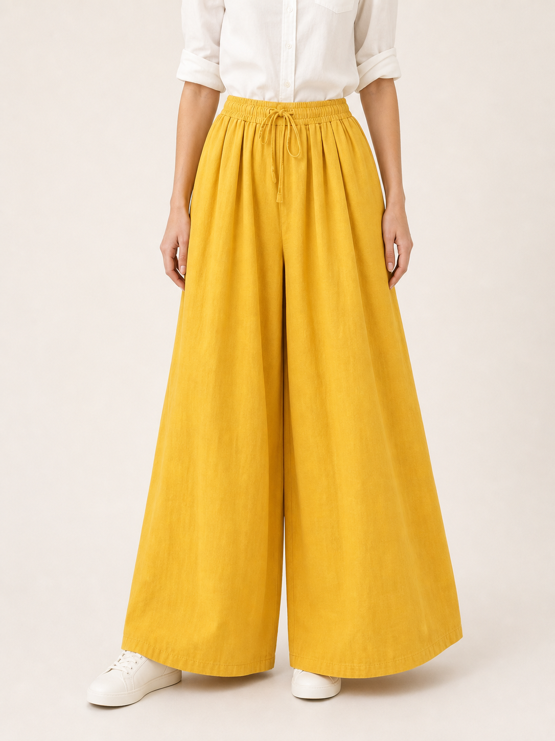 Mustard-colored wide-leg pants with long pant legs