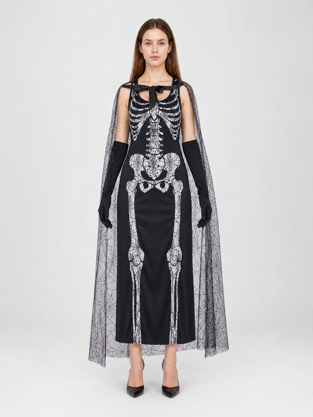 Gothic Halloween costume dress with accessories: a sleeveless black dress with a white rib and pelvic bone print, a sheer cape or veil with a spiderweb design, black gloves, and a necktie or bow detail. The look is done in black and white w