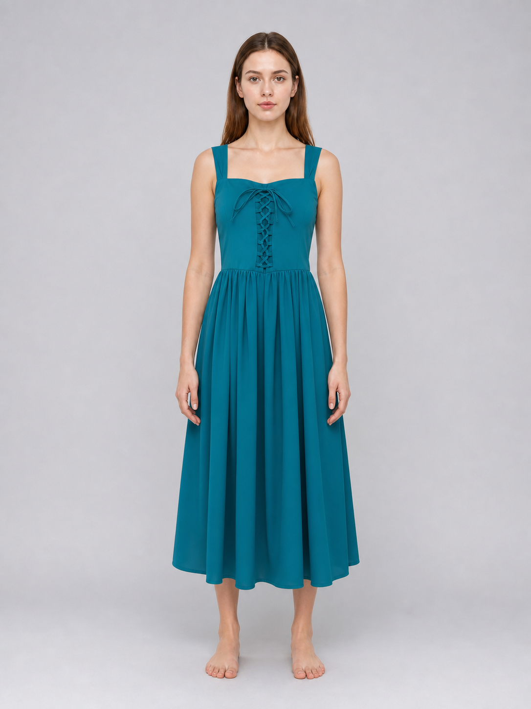 Teal dress with square neckline, wide shoulder straps, front lacing, and a full gathered skirt shown on a model