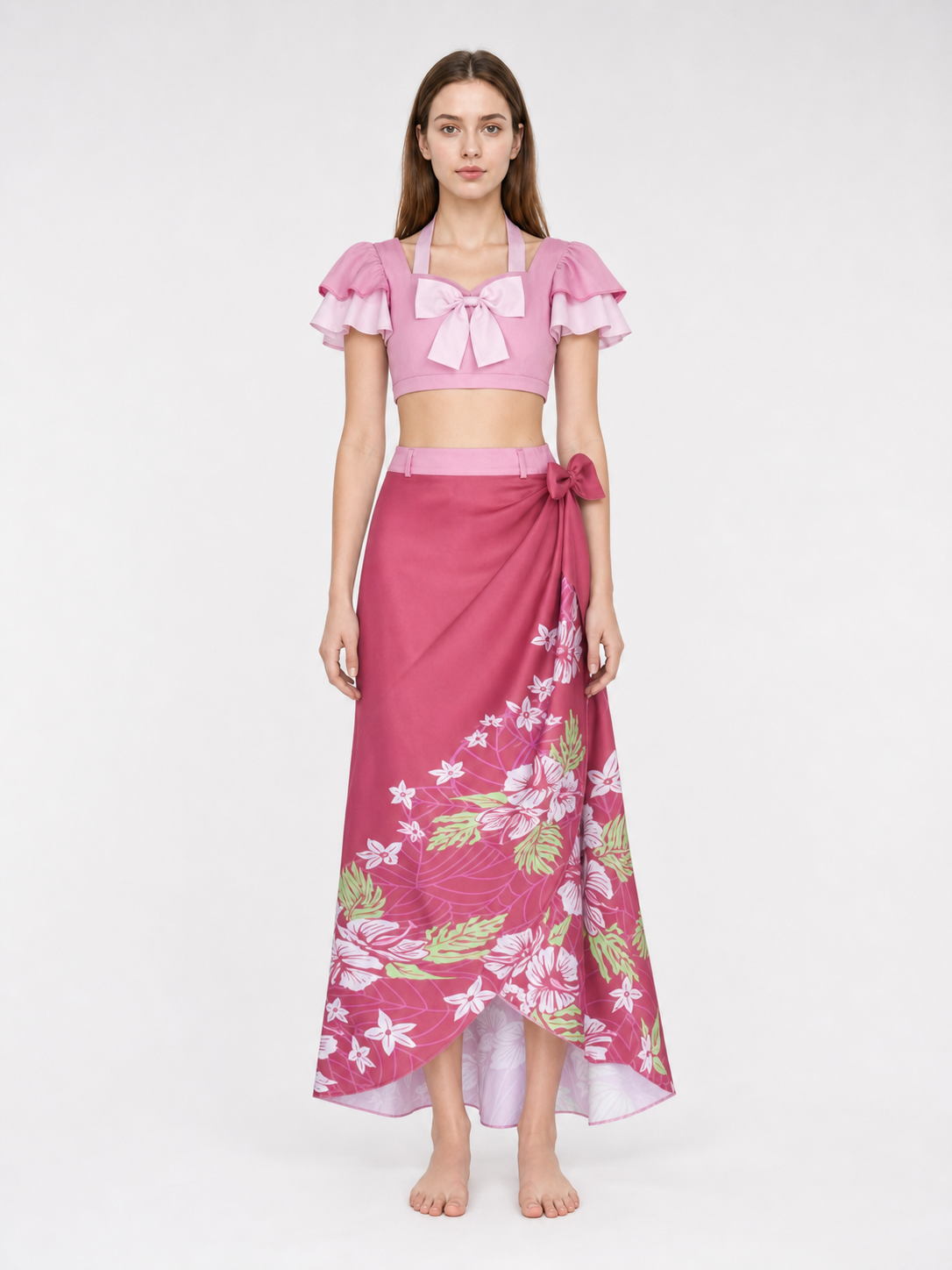 This cosplay set is designed as a short-sleeve crop top and a long skirt. It includes a top, a half-skirt, and decorative bows. There is a bow on the chest of the top, and another bow is placed on the side of the skirt waist. The top has an