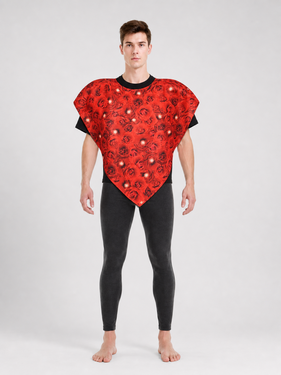 Bright heart-shaped costume with a floral print. A voluminous silhouette with a pointed lower edge and wide short sleeves that extend from the sides of the garment. The surface is decorated with an allover floral pattern reminiscent of rose