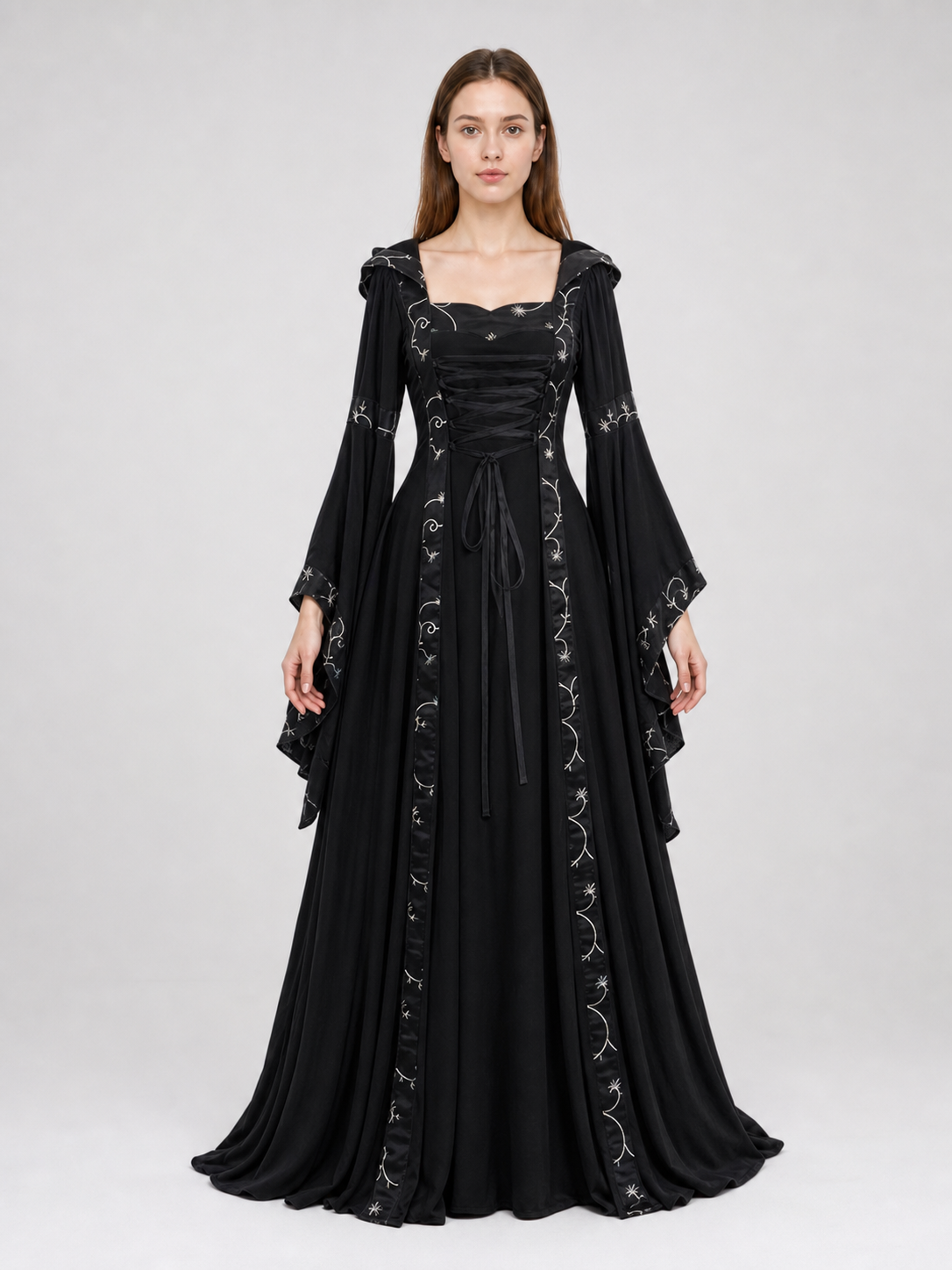 The dress is designed in a gothic style with elements of Victorian aesthetics. The model features a flared silhouette, a square neckline, and long sleeves with flared cuffs. The bodice is decorated with gathers that emphasize the garment’s 