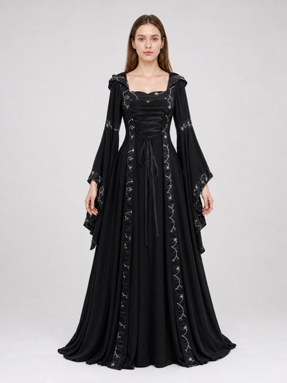 The dress is designed in a gothic style with elements of Victorian aesthetics. The model features a flared silhouette, a square neckline, and long sleeves with flared cuffs. The bodice is decorated with gathers that emphasize the garment’s 
