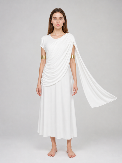 Front-facing model wearing a white draped dress with a long train, gold arm bands, leaf headband and dangling earrings