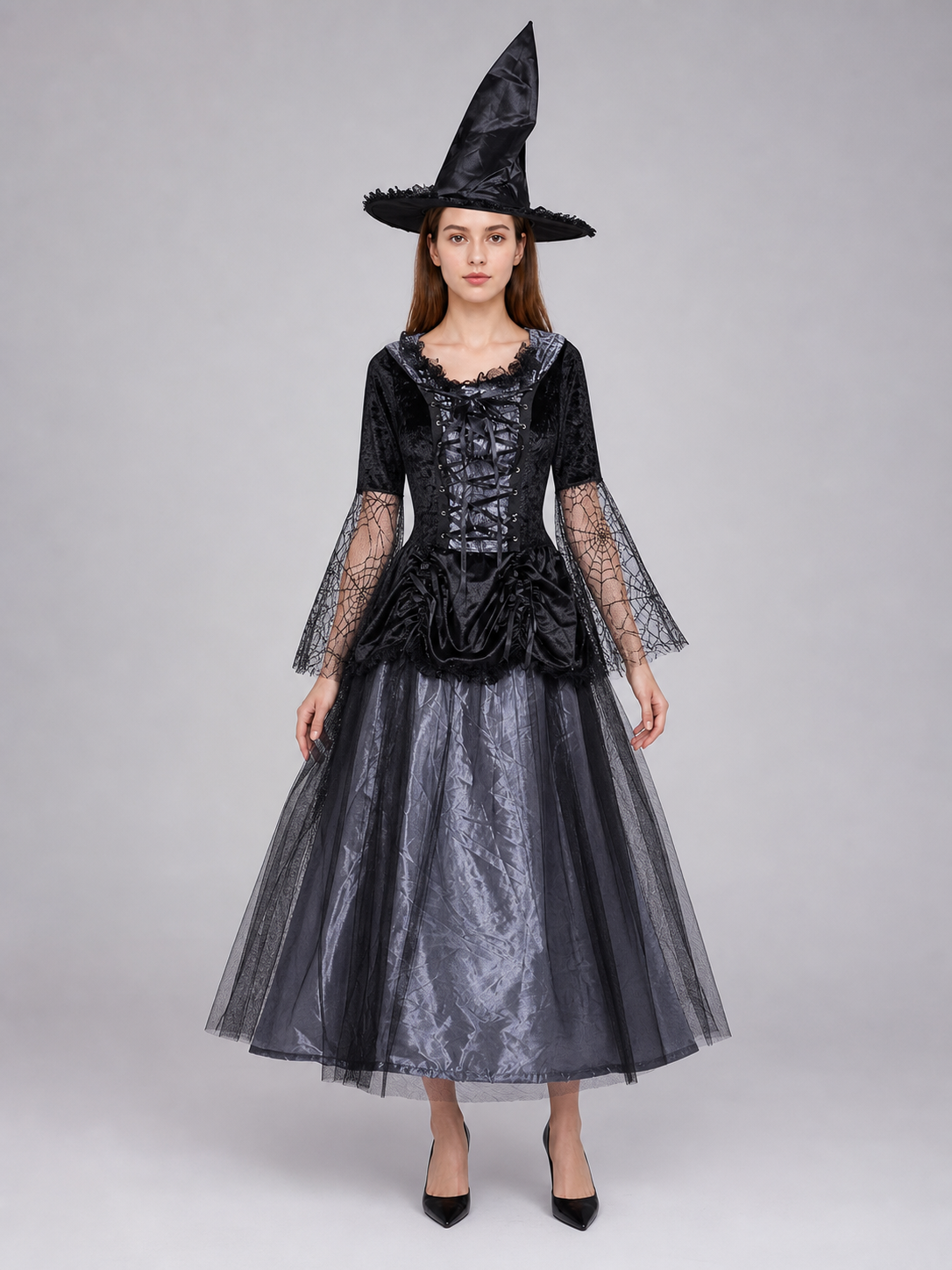 Gothic-style witch costume dress with hat for themed events. The design is mainly black and dark gray, with patterned textured fabric and sheer black accents. The look is centered on a long dress with a fitted lace-up corset, a ruffled neck