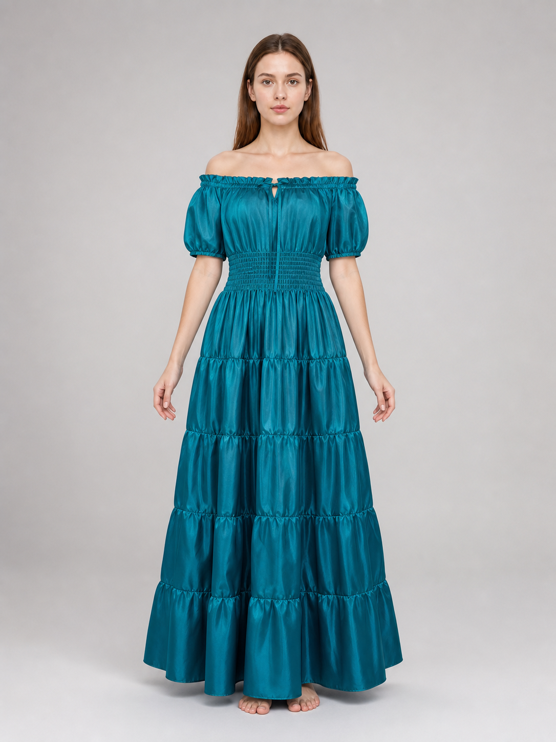Front view of a teal maxi dress on a model, featuring a ruffled off-shoulder neckline, short puff sleeves, smocked bodice, and layered skirt