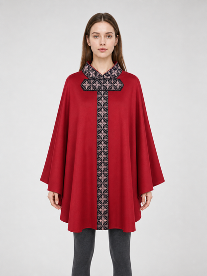 The cape is red with black decorative elements. It has a loose cloak-style silhouette, wide sleeves, and a collar with black patterned detailing. The front features a vertical decorative stripe down the center and a horizontal stripe across