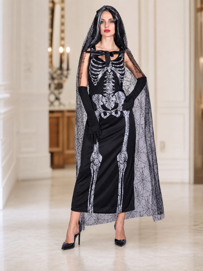 Gothic Halloween costume dress with accessories: a sleeveless black dress with a white rib and pelvic bone print, a sheer cape or veil with a spiderweb design, black gloves, and a necktie or bow detail. The look is done in black and white w