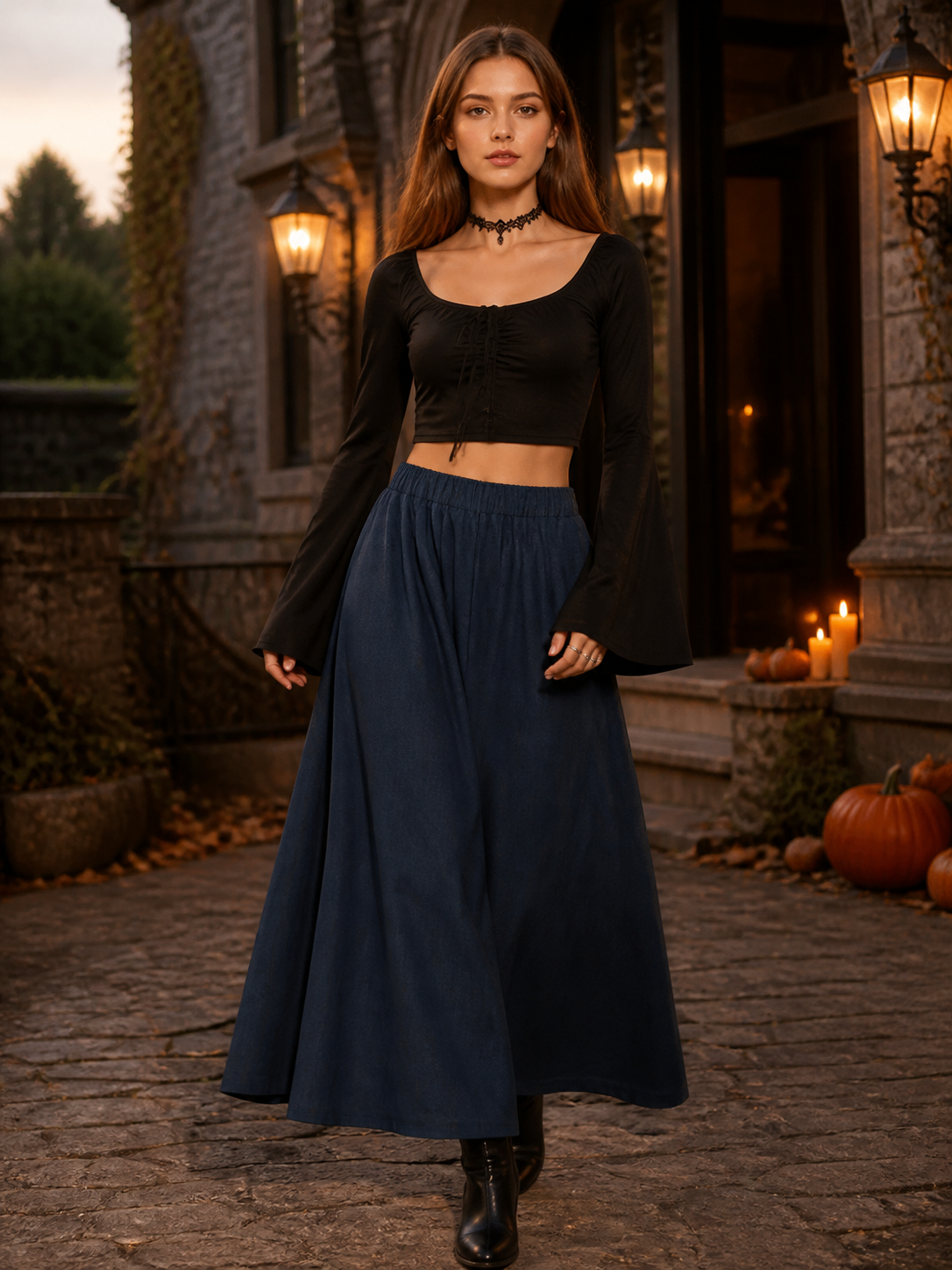 Dark blue wide leg pants worn with a black long-sleeve top and boots in an outdoor evening setting