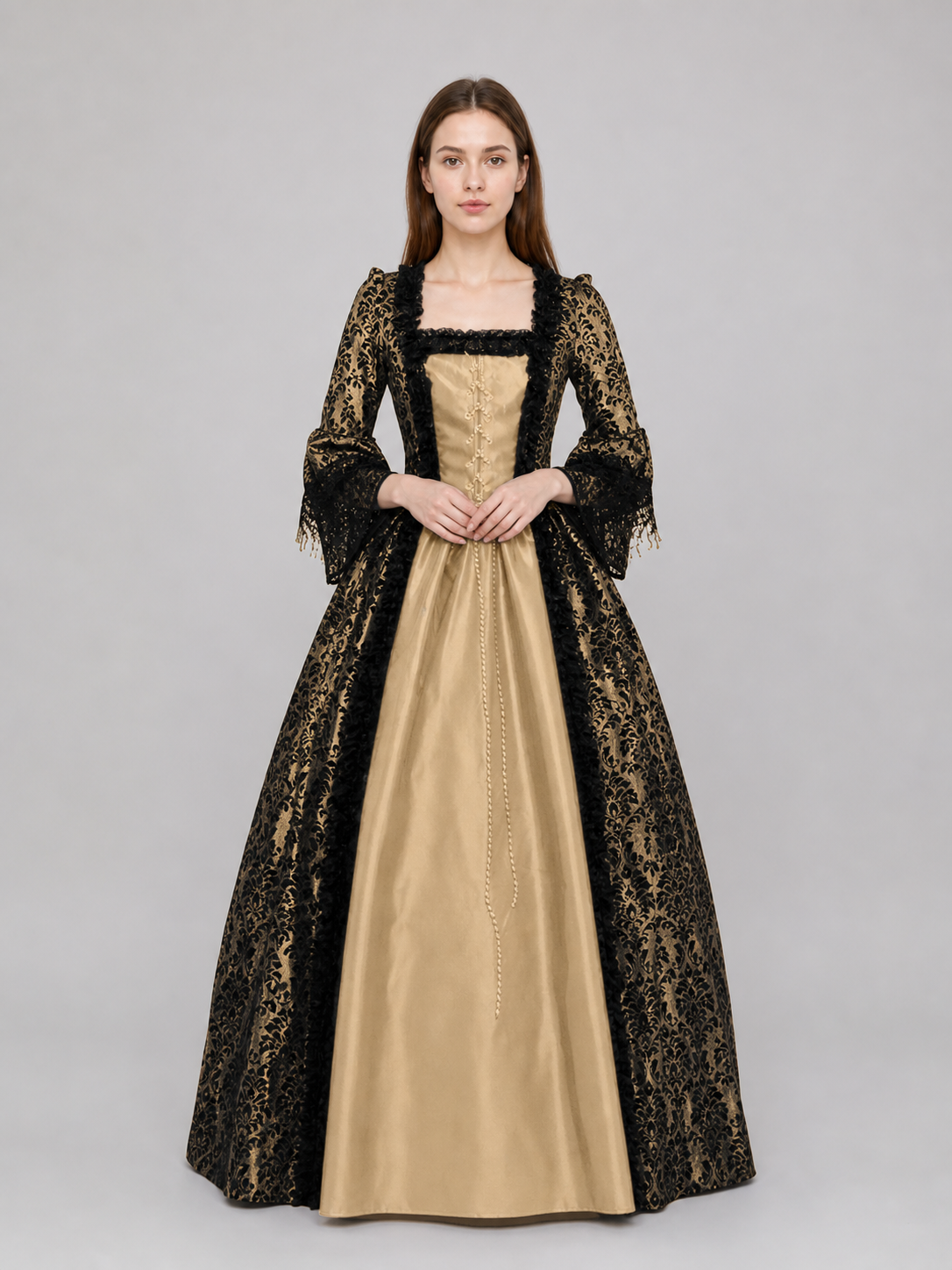 The dress is designed in a historical style with theatrical and decorative details. A golden-beige center is paired with black outer panels and damask-patterned trim, creating a striking contrast. The fitted bodice is decorated with visible