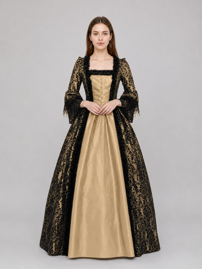The dress is designed in a historical style with theatrical and decorative details. A golden-beige center is paired with black outer panels and damask-patterned trim, creating a striking contrast. The fitted bodice is decorated with visible
