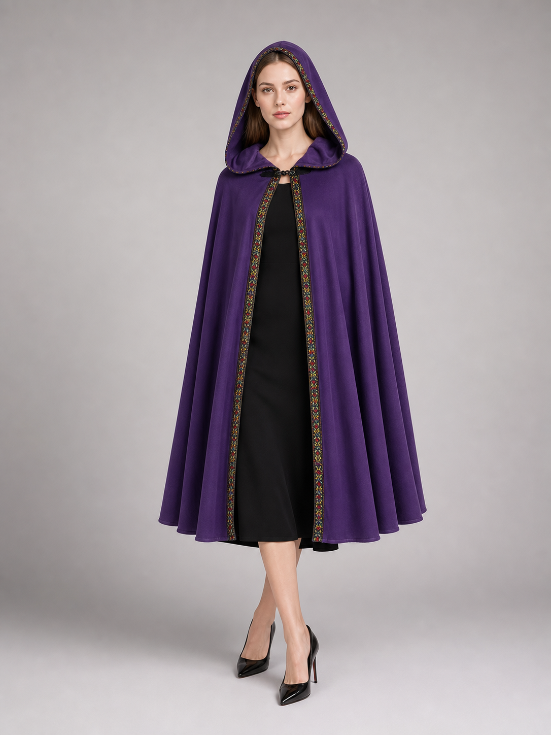 Purple hooded cape with patterned trim, shown full-length on a model over a black dress 4