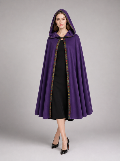 Purple hooded cape with patterned trim, shown full-length on a model over a black dress 4