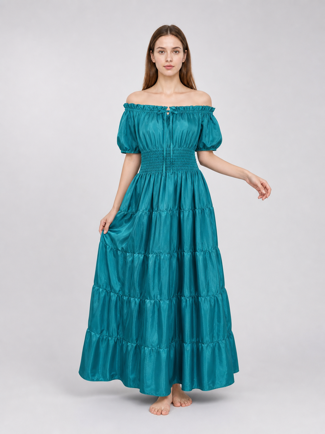 Teal satin-look dress shown full length on a model, with an off-shoulder neckline, short puff sleeves, smocked waist, and gathered tiered skirt