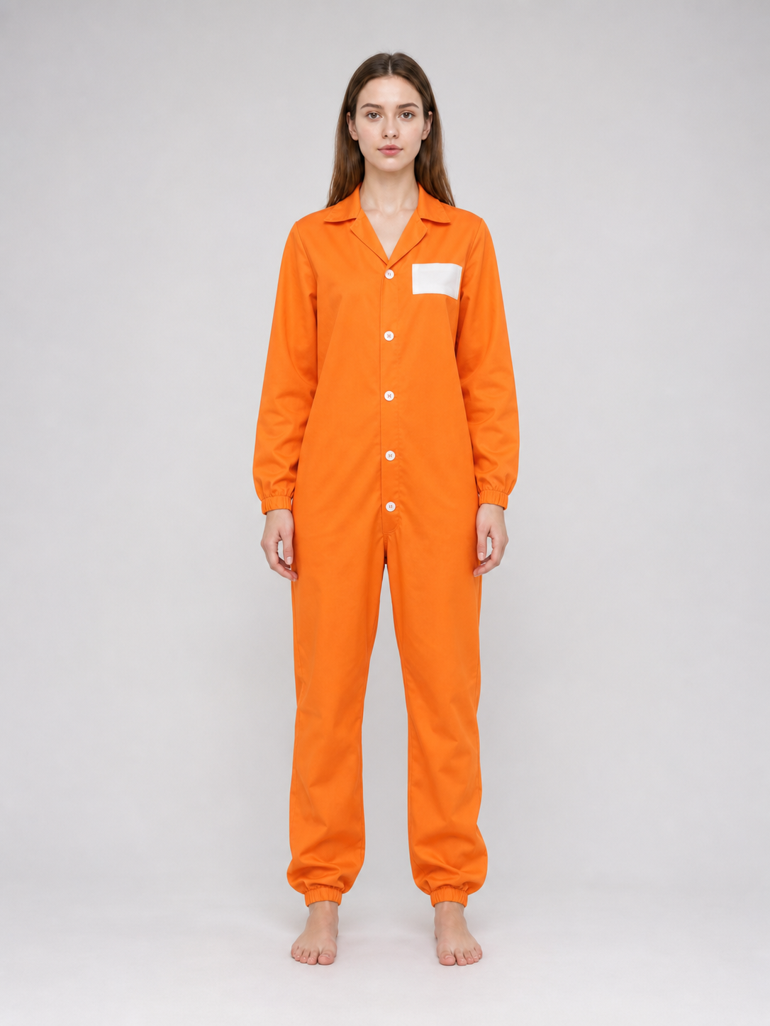 Close-up of the orange jumpsuit showing its pointed collar, white chest patch, white front buttons, and gathered sleeve cuff