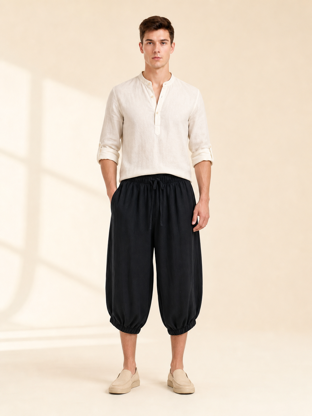 Black cropped pants with an elastic waist and loose legs, styled with a light shirt and slip-on shoes