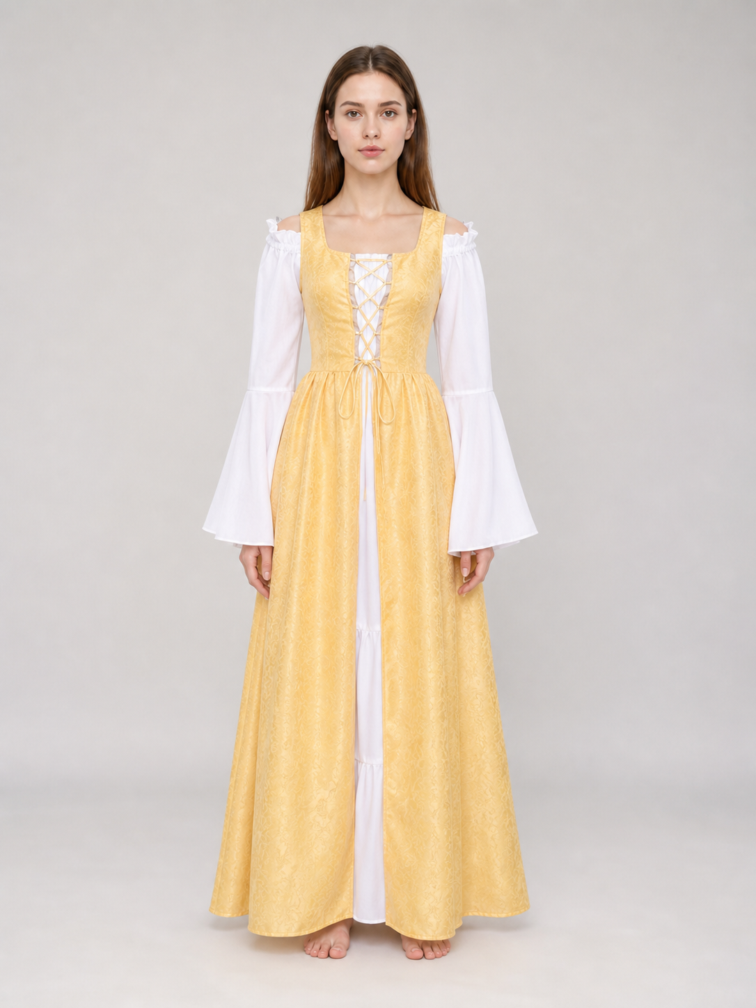 The yellow dress is designed in a fairytale costume style with expressive details inspired by medieval and Renaissance looks. It features a long, floor-length silhouette and a flared skirt paired with a fitted waistline. The front of the bo