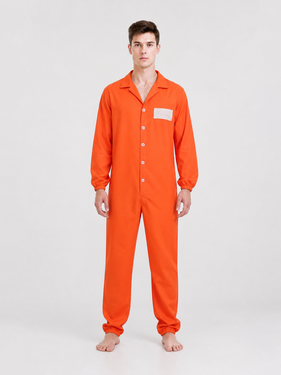 Orange coverall with a smooth fabric look, collared button front, chest patch, and elastic cuffs, shown full-body on a barefoot model