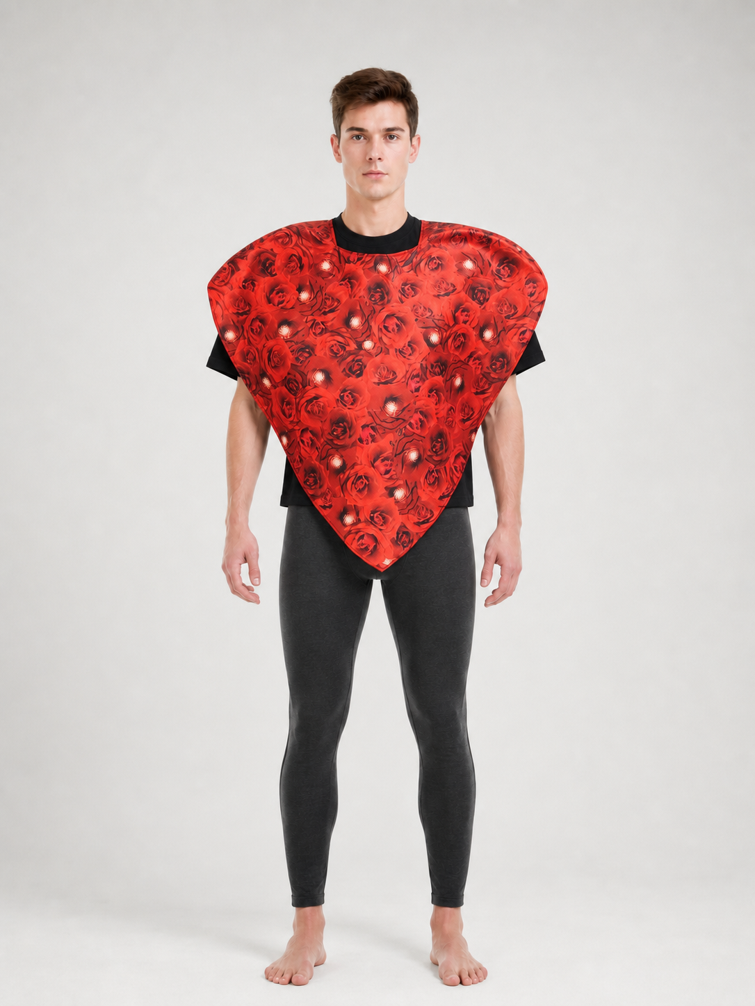 Bright heart-shaped costume with a floral print. A voluminous silhouette with a pointed lower edge and wide short sleeves that extend from the sides of the garment. The surface is decorated with an allover floral pattern reminiscent of rose
