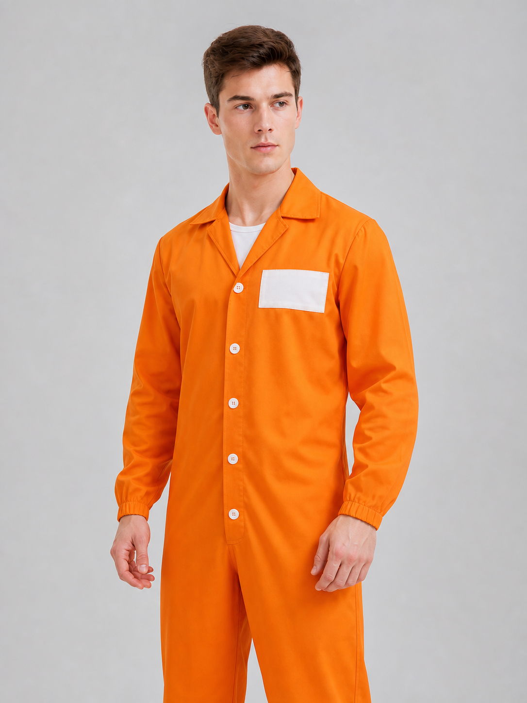 Full-body model wearing an orange button-front jumpsuit with pointed collar, white chest patch, and black boots