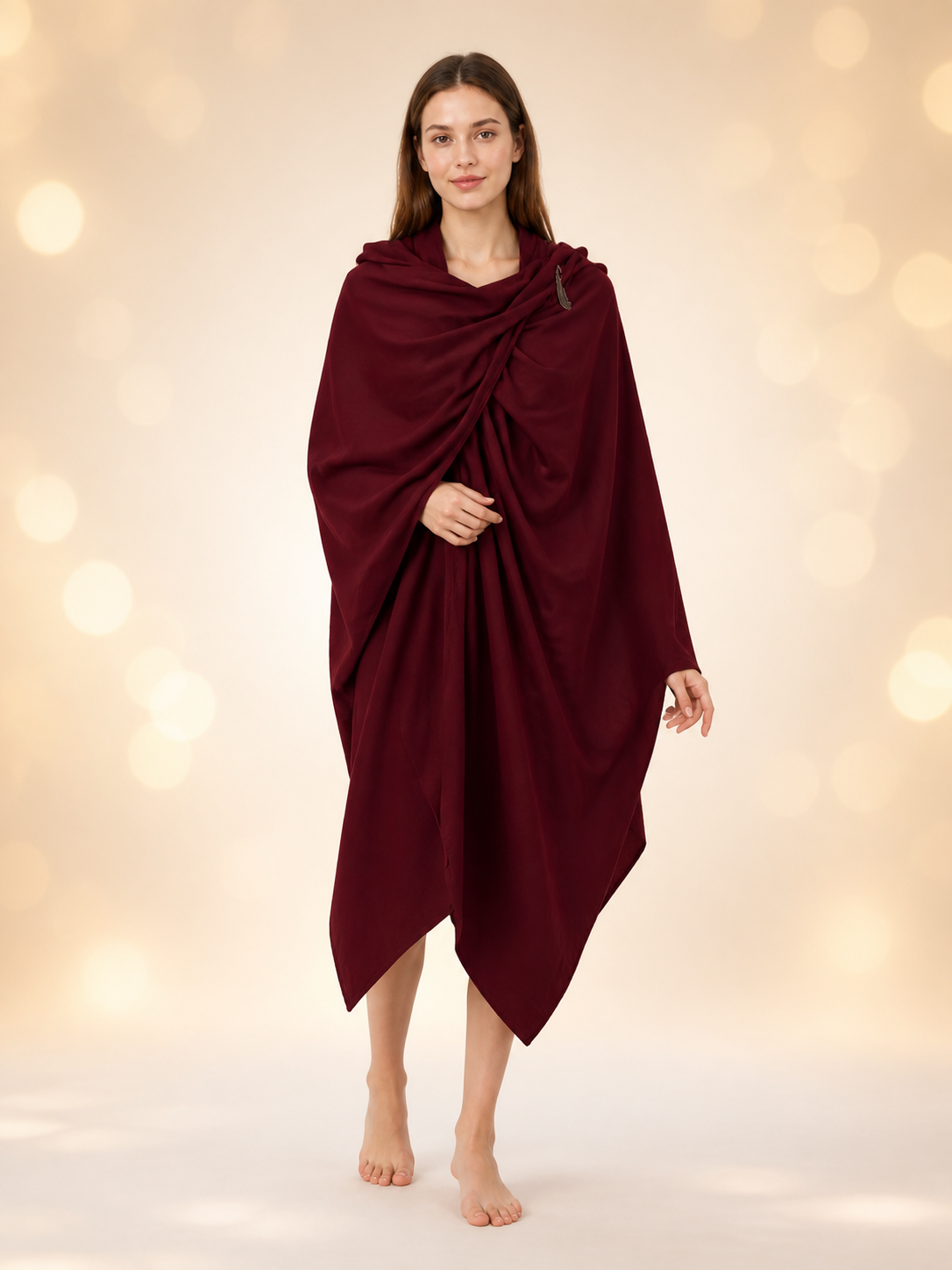 Burgundy cloak with hood and gathered front, modeled full length by a woman against a warm bokeh background