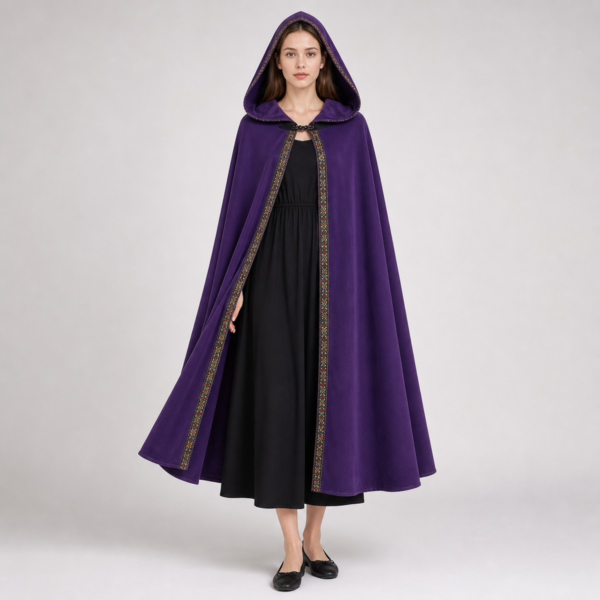 Open purple hooded cape with patterned trim, shown on a model over a long black dress