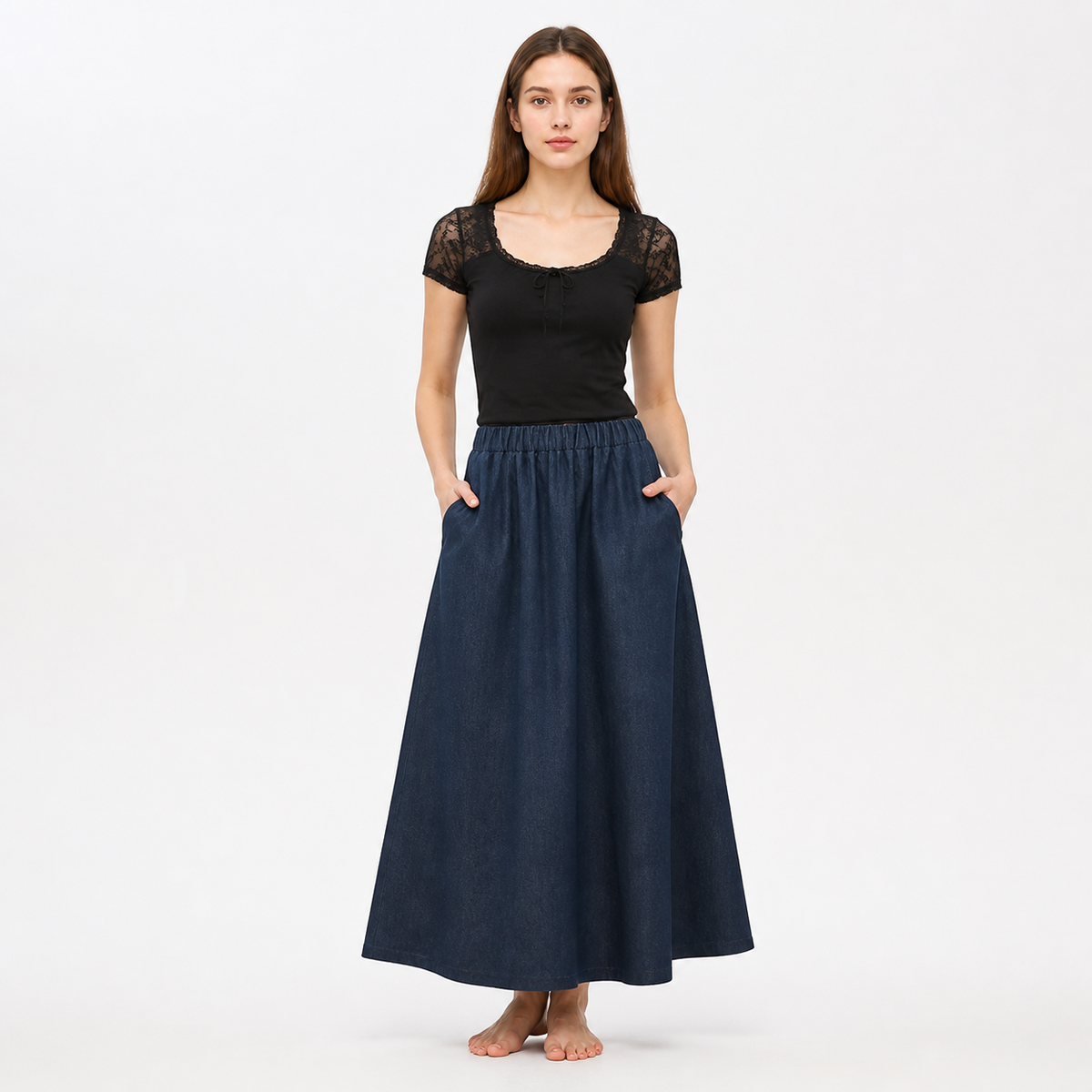 Full-body model wearing dark blue wide leg pants with side pockets and an elastic waistband, styled with a black top