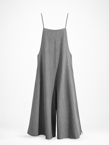 Gray wide-leg jumpsuit displayed on a stand against a white background, showing thin straps, side pockets, and a flowing silhouette