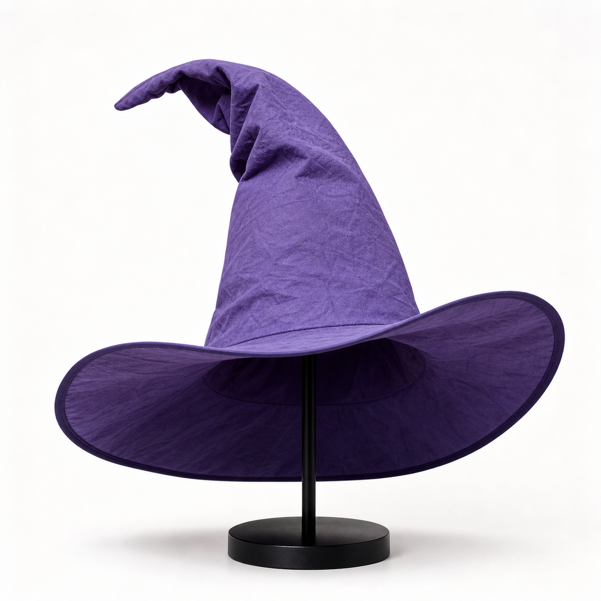 Purple pointed witch hat displayed on a black stand, showing its wide brim, bent top, and dark interior