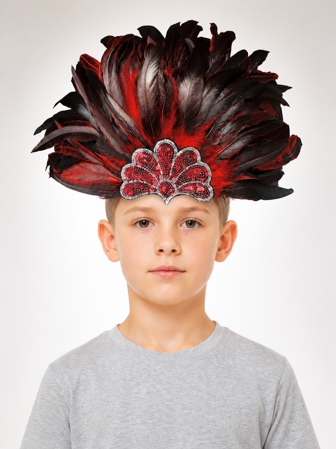 Red and black feathered headpiece with a jeweled red centerpiece, shown on a child wearing a gray shirt