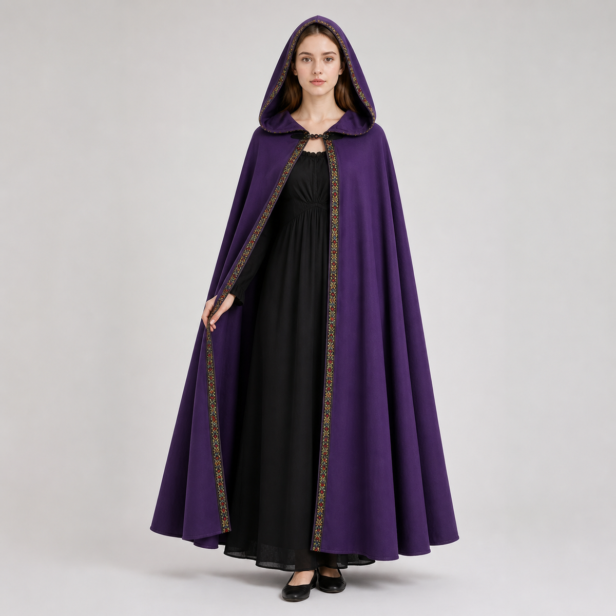 Information card about the purple hooded cape, showing velvet fabric, a neckline clasp, and decorative edge trim