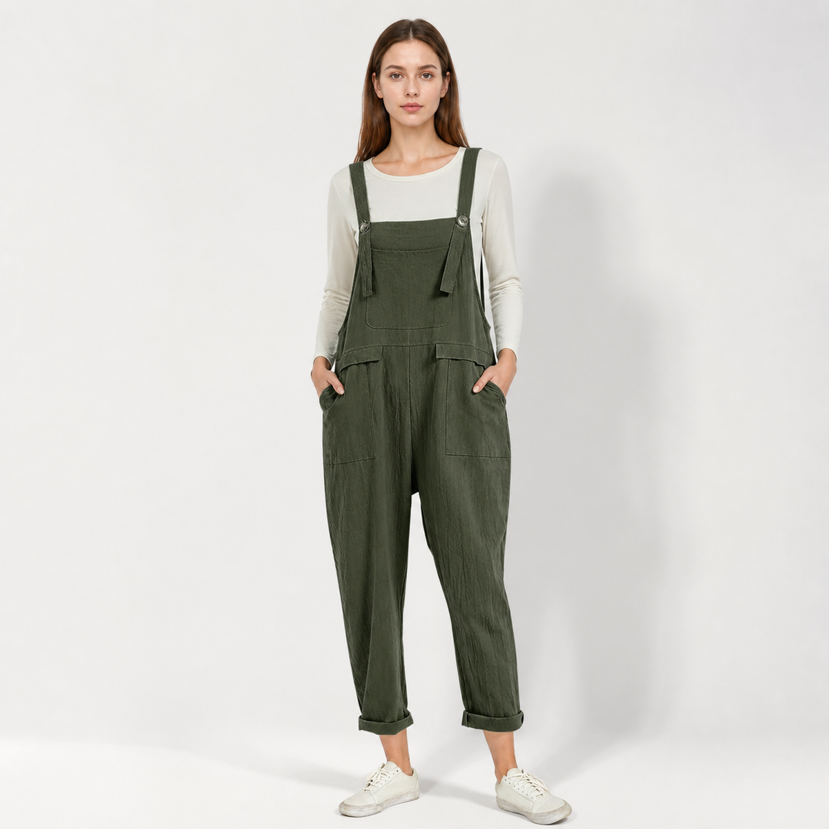 Full-body front view of dark green textured bib overalls with a chest pocket, adjustable shoulder straps, side pockets, and rolled cuffs