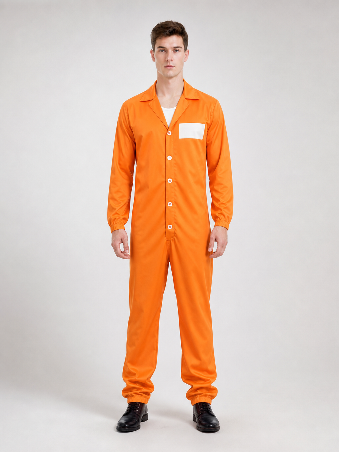 Front view of a model in an orange long-sleeve jumpsuit with pointed collar, white chest patch, front buttons, and black boots