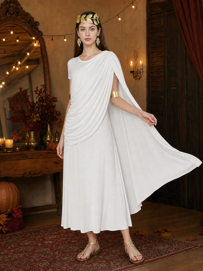 Three-quarter model view of a white draped dress with a long flowing train, gold arm bands, leaf headband and flat sandals