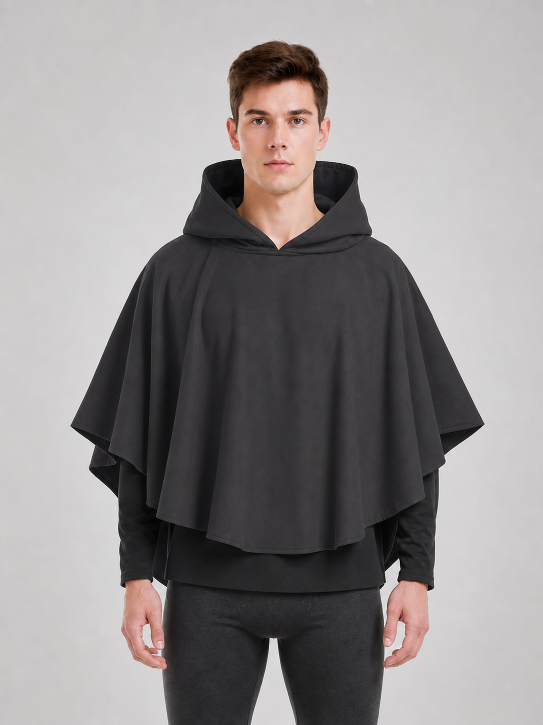 Dark gray hooded poncho with a broad hood and layered front panels, shown in a close studio view
