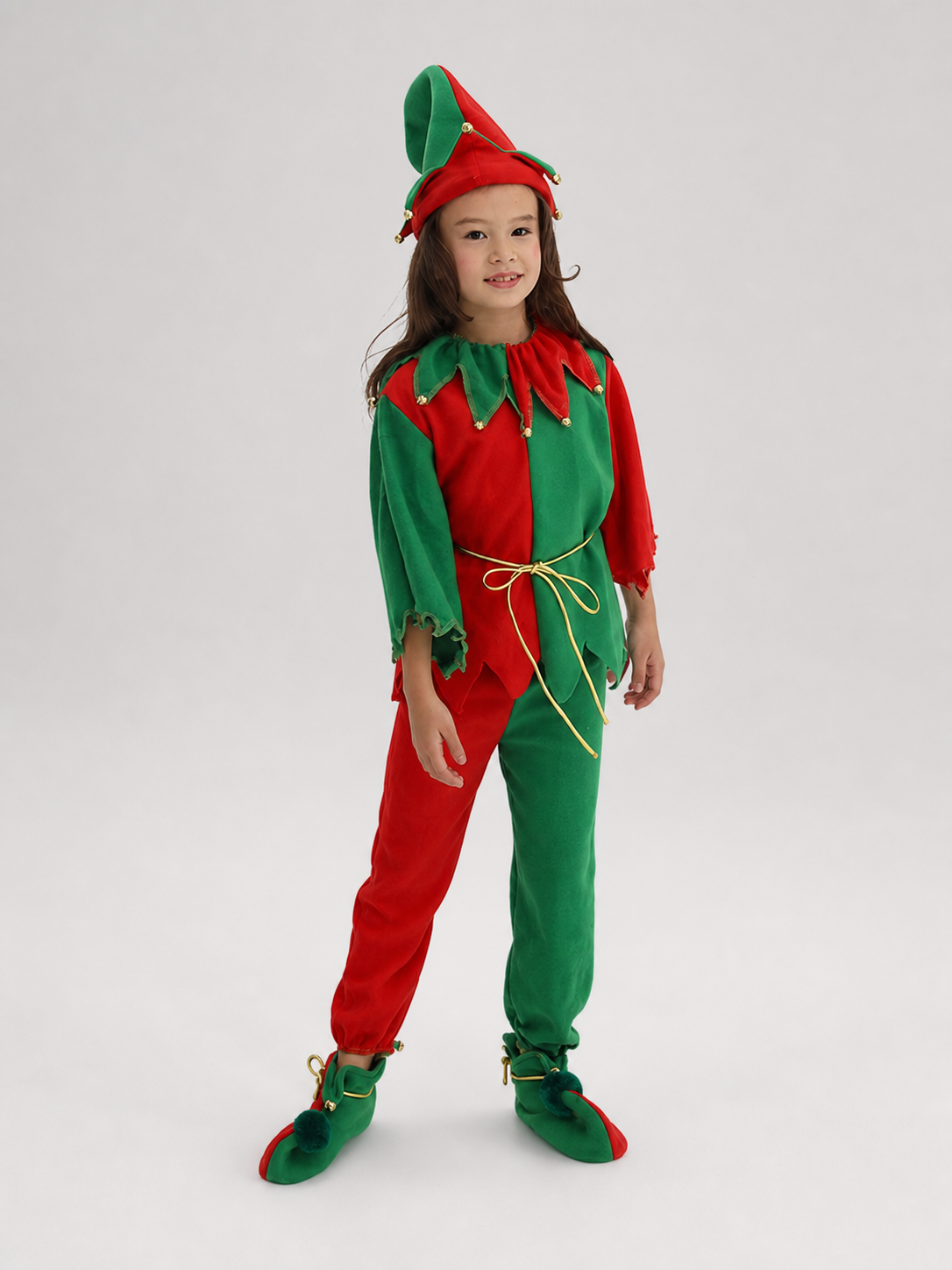 Children's Christmas elf costume in a festive red-and-green design with gold and yellow trim. The set includes a pointed hat with a curled tip and small dangling decorative elements, a long-sleeve top, pants, a gold tie belt for the waist, 