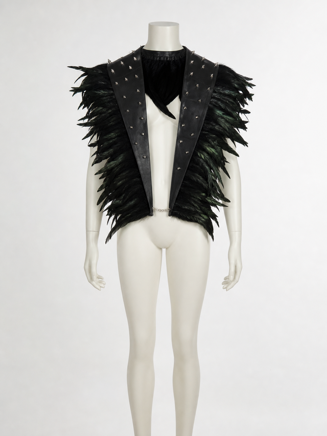 Front view of a black feathered cape collar on a mannequin, showing pointed studded leather lapels and a neck tie