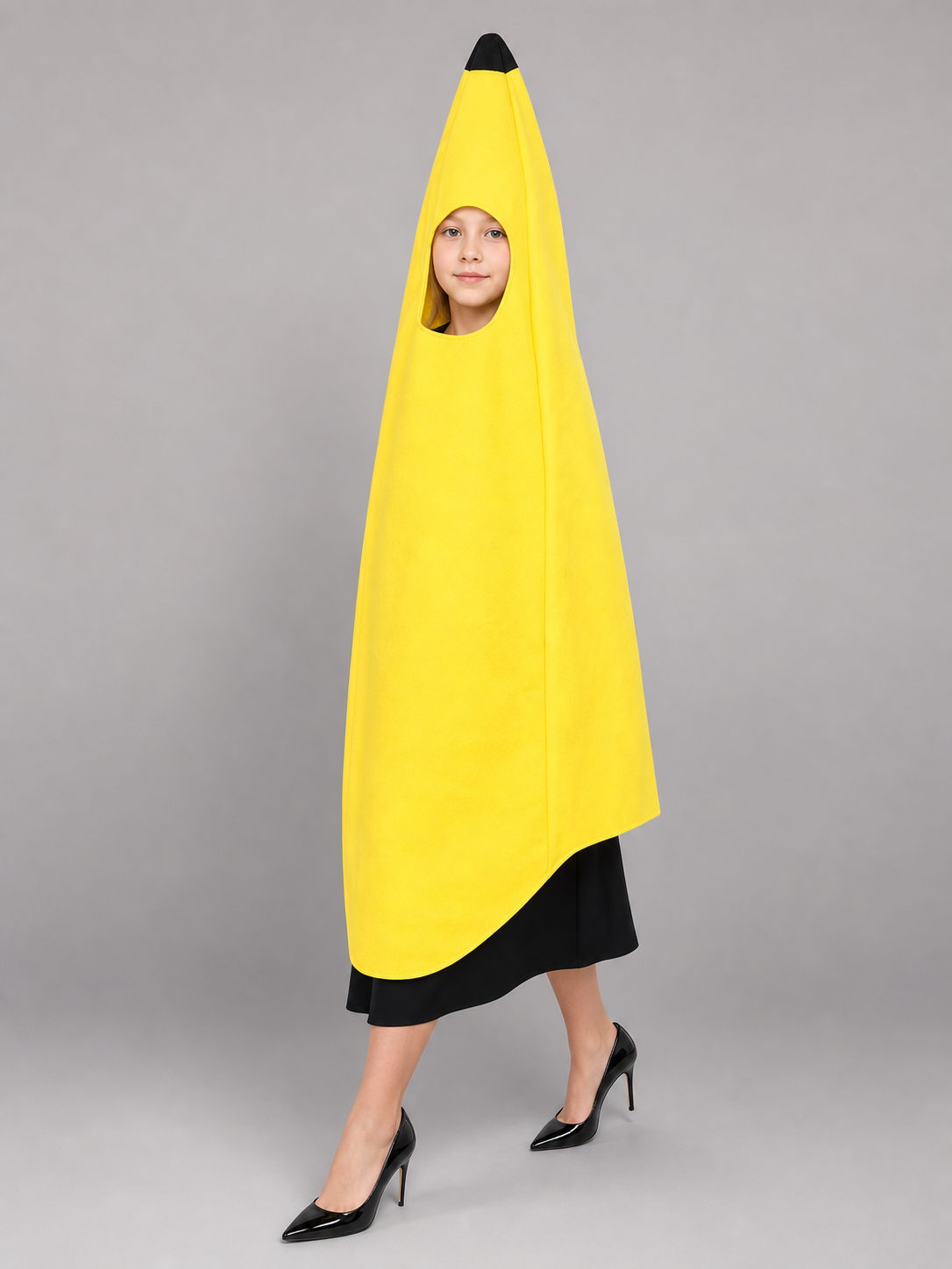 Bright banana-shaped costume for dress-up and fun events. The design is a tall, elongated banana: the main color is rich yellow, and the top is finished with a black pointed tip. There is a face opening in the upper area, and the open secti