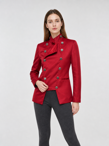 The jacket is presented in a vintage red color and designed in a military style with elements of Gothic aesthetics. The model features a distinctive front construction with a diagonal wrap, giving the garment a bold character. A double row 