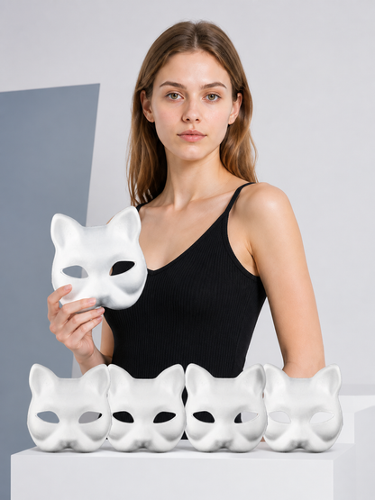 Model holding a white cat mask with four more matching masks on the table
