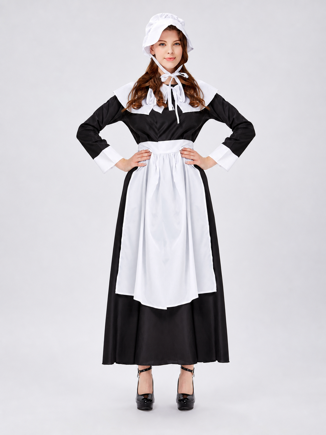 The uniform costume is designed in a black-and-white color scheme and combines elements of a classic maid outfit with a stage costume format. The model creates a complete look with a black top and skirt, long sleeves, white cuffs, a wide wh