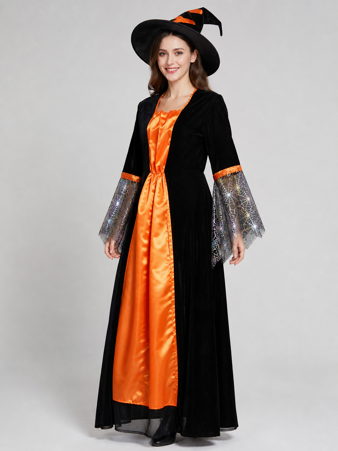 Witch-style costume set featuring a long black dress with long sleeves, a wide flared bottom, and a black pointed hat. The design uses orange, silver, and black colors. The center front of the dress features an orange decorative element, an