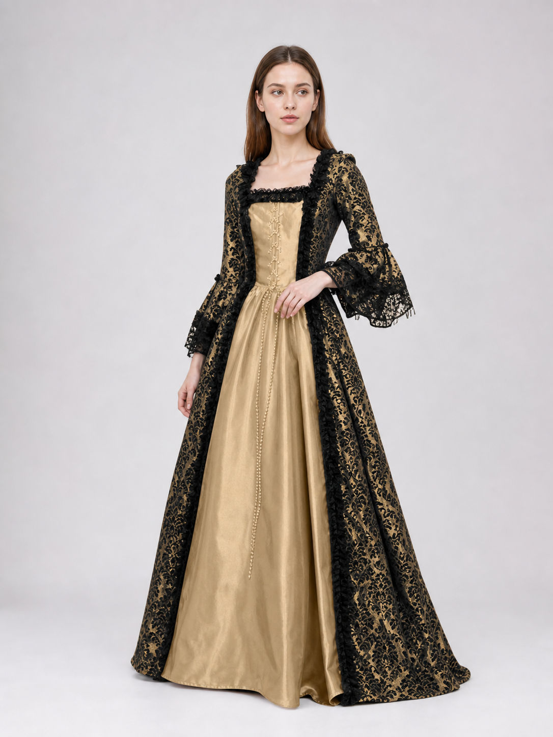 The dress is designed in a historical style with theatrical and decorative details. A golden-beige center is paired with black outer panels and damask-patterned trim, creating a striking contrast. The fitted bodice is decorated with visible