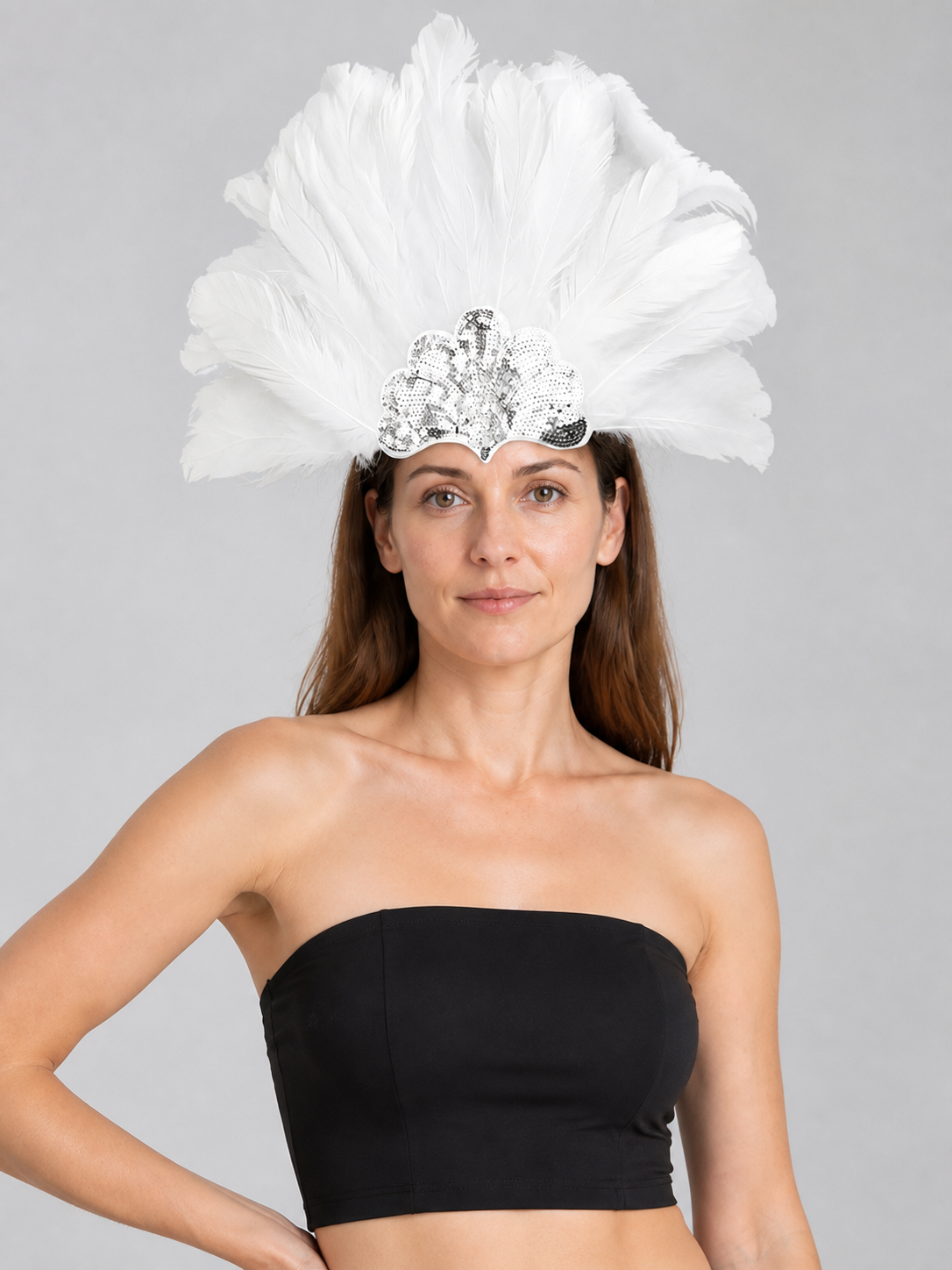 Model wearing the white feather headband with a black strapless top, showing the large feather fan and silver sequins