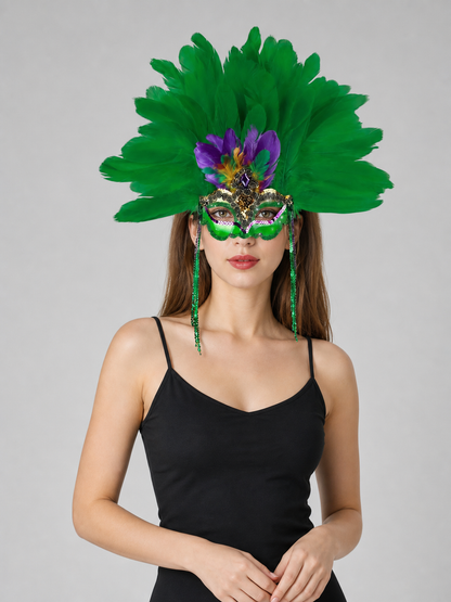 Woman wearing a large green feather mask with purple accents and long green strands, shown against a plain gray background