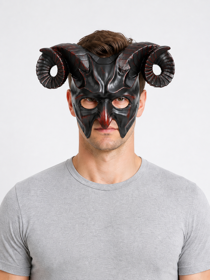Man wearing a glossy black horned mask with curled ridged horns and pointed facial details, shown in a front portrait
